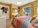 Bedroom with hardwood floors, window, and colorful bedding at 642 N Jefferson Ave # 13, Sarasota, FL 34237