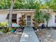 Front view of charming bungalow with landscaped yard and walkway at 642 N Jefferson Ave # 13, Sarasota, FL 34237