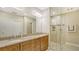 Double vanity bathroom with granite countertops and a large walk-in shower at 7546 Divot Loop, Lakewood Ranch, FL 34202