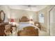 Bedroom with antique wooden bed frame and ceiling fan at 7546 Divot Loop, Lakewood Ranch, FL 34202