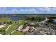 Aerial view of clubhouse with adjacent parking and golf course at 7546 Divot Loop, Lakewood Ranch, FL 34202