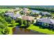 Aerial view of home nestled in a community with water features and golf course at 7546 Divot Loop, Lakewood Ranch, FL 34202