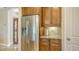 Kitchen boasts stainless steel refrigerator and wood cabinets at 7546 Divot Loop, Lakewood Ranch, FL 34202