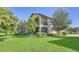 Two-story home with screened balcony and manicured lawn at 7546 Divot Loop, Lakewood Ranch, FL 34202