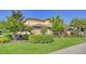 Two-story house with lush landscaping and brick walkway at 7546 Divot Loop, Lakewood Ranch, FL 34202