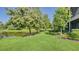 Landscaped backyard with pond and lush greenery at 7546 Divot Loop, Lakewood Ranch, FL 34202