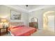Bedroom with king-size bed, dresser, and ensuite bathroom access at 7546 Divot Loop, Lakewood Ranch, FL 34202