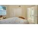 Bedroom with antique bed, chair, and access to bathroom at 7546 Divot Loop, Lakewood Ranch, FL 34202