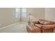 Cozy sitting area with leather chair and ottoman, near window at 7546 Divot Loop, Lakewood Ranch, FL 34202