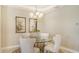 Elegant dining room with glass-top table and four upholstered chairs at 7546 Divot Loop, Lakewood Ranch, FL 34202