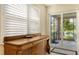 Elegant entryway with wooden buffet and sliding glass doors to patio at 7546 Divot Loop, Lakewood Ranch, FL 34202