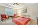 Bedroom with king-size bed, two armchairs, and plantation shutters at 7546 Divot Loop, Lakewood Ranch, FL 34202