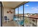 Screened balcony with seating, offering a relaxing outdoor space at 6157 Midnight Pass Rd # E65, Sarasota, FL 34242