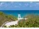 Private beach access with white sand and ocean view at 6157 Midnight Pass Rd # E65, Sarasota, FL 34242