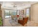 Bright and airy living room with a sectional sofa, glass coffee table, and access to a patio at 8744 Bellussi Dr, Sarasota, FL 34238
