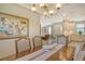 Bright dining room with a wooden table, four chairs and a view into the kitchen at 8744 Bellussi Dr, Sarasota, FL 34238