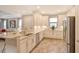 Modern kitchen with white cabinets, granite countertops, and stainless steel appliances at 8744 Bellussi Dr, Sarasota, FL 34238