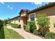 Welcoming house entrance with a brick walkway, landscaping, and stylish planters at 8744 Bellussi Dr, Sarasota, FL 34238