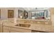Modern kitchen features a large island with granite countertops and stainless steel sink at 8744 Bellussi Dr, Sarasota, FL 34238