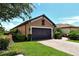 Two-car garage with decorative doors and landscaping at 8744 Bellussi Dr, Sarasota, FL 34238