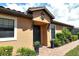 Elegant home exterior featuring a dark-colored front door and manicured landscaping at 8744 Bellussi Dr, Sarasota, FL 34238