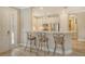 Kitchen features a breakfast bar with three stools and granite countertops at 8744 Bellussi Dr, Sarasota, FL 34238