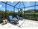 Screened patio with lounge chairs for relaxing at 8744 Bellussi Dr, Sarasota, FL 34238