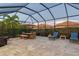 Screened patio with dining table and lounge chairs at 8744 Bellussi Dr, Sarasota, FL 34238