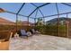 Relaxing screened patio with lounge chairs at 8744 Bellussi Dr, Sarasota, FL 34238