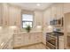 Modern kitchen with white cabinets, granite countertops, and stainless steel appliances at 8744 Bellussi Dr, Sarasota, FL 34238