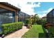 Landscaped backyard with brick pavers and lush greenery at 8744 Bellussi Dr, Sarasota, FL 34238