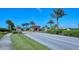 Gated community entrance with palm trees and landscaping at 8744 Bellussi Dr, Sarasota, FL 34238