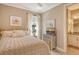 Guest bedroom with gold bed frame and en-suite bathroom at 8744 Bellussi Dr, Sarasota, FL 34238