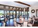 Community room with tables, chairs, and large windows overlooking pool at 8744 Bellussi Dr, Sarasota, FL 34238