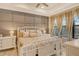 Spacious bedroom with a king-size bed, neutral color palette and large windows at 8744 Bellussi Dr, Sarasota, FL 34238