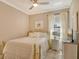 Charming bedroom with a gold metal bed frame and window seating at 8744 Bellussi Dr, Sarasota, FL 34238
