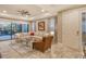 Bright and airy living room with a sectional sofa, glass coffee table, and access to a patio at 8744 Bellussi Dr, Sarasota, FL 34238