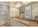 Double vanity bathroom with grey countertops and a shower/tub combo at 8744 Bellussi Dr, Sarasota, FL 34238
