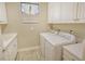 Laundry room with white cabinets, washer, and dryer at 8744 Bellussi Dr, Sarasota, FL 34238