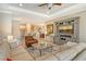 Open living room with comfortable seating and views into the kitchen and dining area at 8744 Bellussi Dr, Sarasota, FL 34238