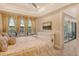 Main bedroom with king-size bed, access to the back patio and neutral decor at 8744 Bellussi Dr, Sarasota, FL 34238
