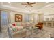 Bright and airy living room with a sectional sofa, glass coffee table, and access to a patio at 8744 Bellussi Dr, Sarasota, FL 34238