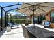 Outdoor dining area on a screened patio at 8744 Bellussi Dr, Sarasota, FL 34238