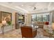 Spacious living room with a comfortable sectional sofa, large TV, and plenty of natural light at 8744 Bellussi Dr, Sarasota, FL 34238