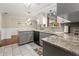 Updated kitchen boasts granite countertops and gray cabinetry at 6401 36Th W Ave, Bradenton, FL 34209