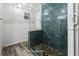 Primary bathroom with a large walk-in shower and pebble floor at 6401 36Th W Ave, Bradenton, FL 34209