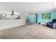 Open concept living and kitchen with carpeted floors and light walls at 6401 36Th W Ave, Bradenton, FL 34209
