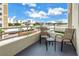 Private balcony with patio furniture and scenic neighborhood views at 6142 Midnight Pass Rd # 14N, Sarasota, FL 34242