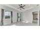 Light-filled bedroom with ceiling fan and access to other rooms at 12734 Rainwashed Loop, Parrish, FL 34219