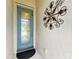 Front entrance with a stylish light blue door and decorative wall art at 12734 Rainwashed Loop, Parrish, FL 34219